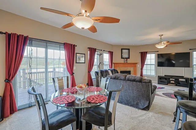 a living room with furniture a flat screen tv and a large window