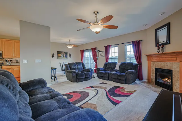 a living room with furniture fireplace and a window