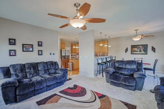 a living room with furniture and a dining table
