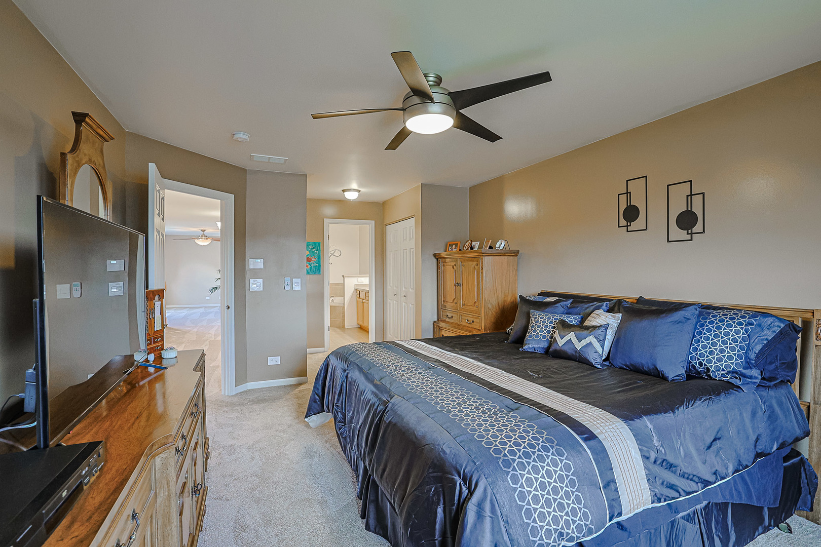 1242 Prairie View Parkway Cary, IL 60013 - Photo 24 of 36 a bedroom with a bed and a chandelier