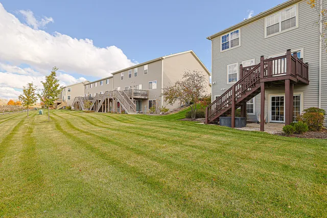 a view of a house next to a big yard