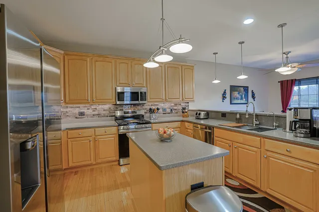 a kitchen with a sink a counter space appliances and cabinets