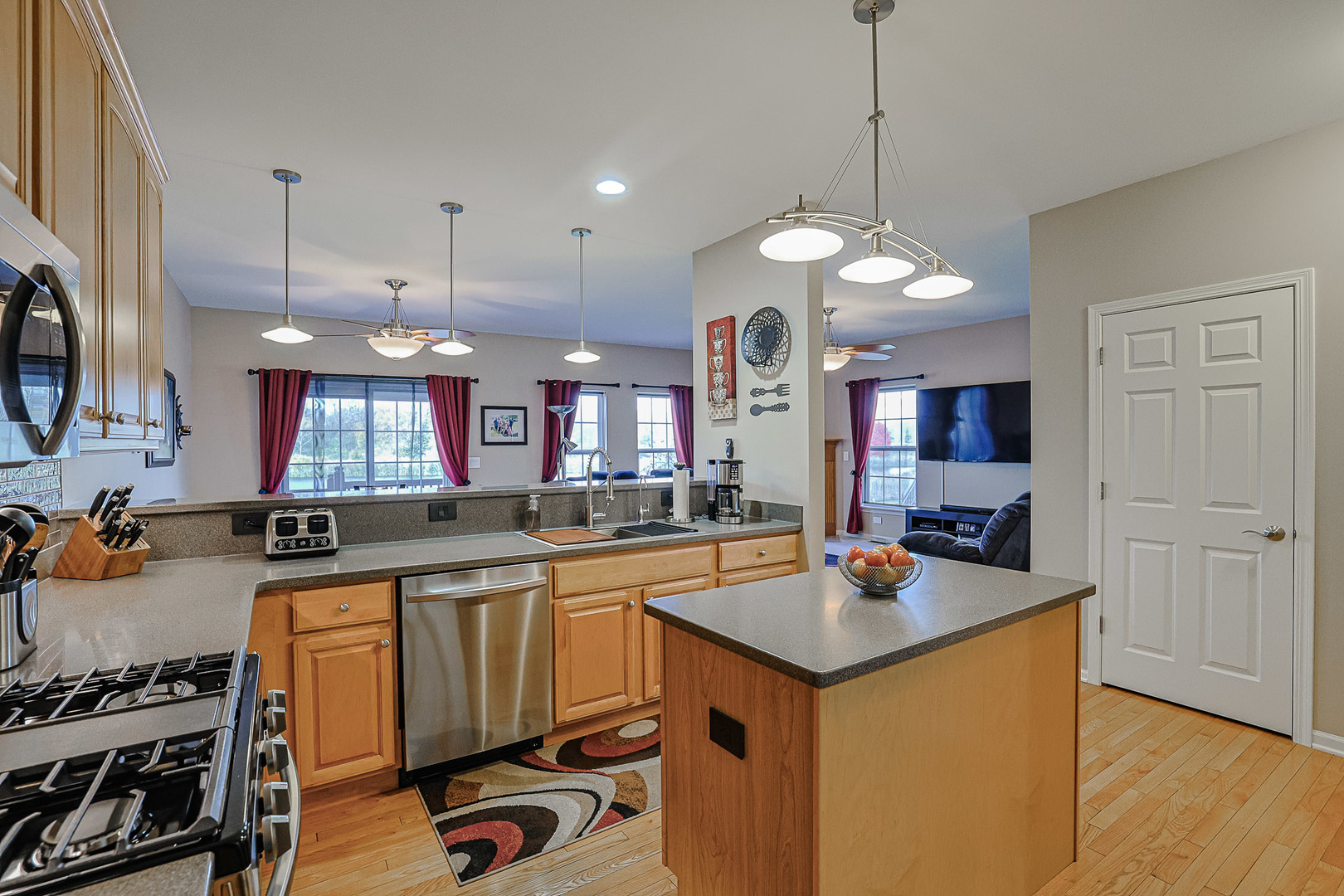 1242 Prairie View Parkway Cary, IL 60013 - Photo 8 of 36 a kitchen that has a lot of cabinets in it and wooden floors