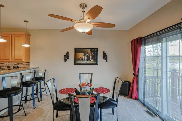 a view of a dining room with furniture and a chandelier