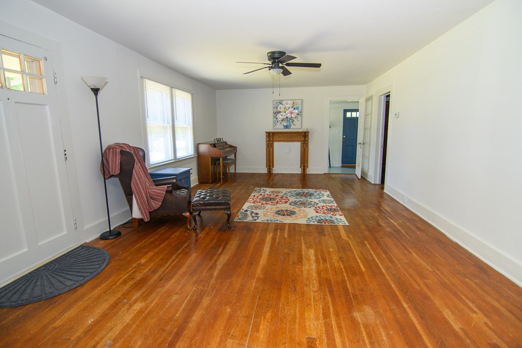 24432 Maxwell Street Parksley, VA 23421 - Photo 13 of 39 a bed sitting in a room next to a window