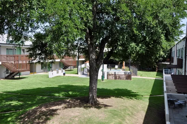 a view of a house with backyard and sitting area