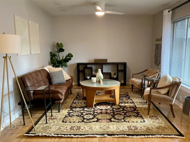 a living room with furniture and a rug