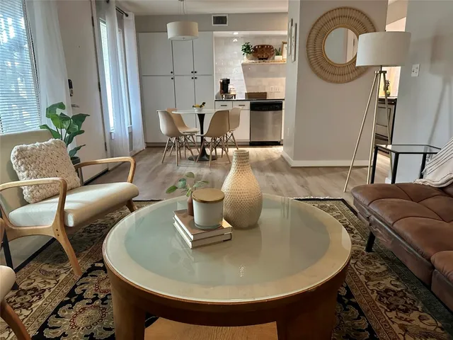 a living room with furniture and a mirror