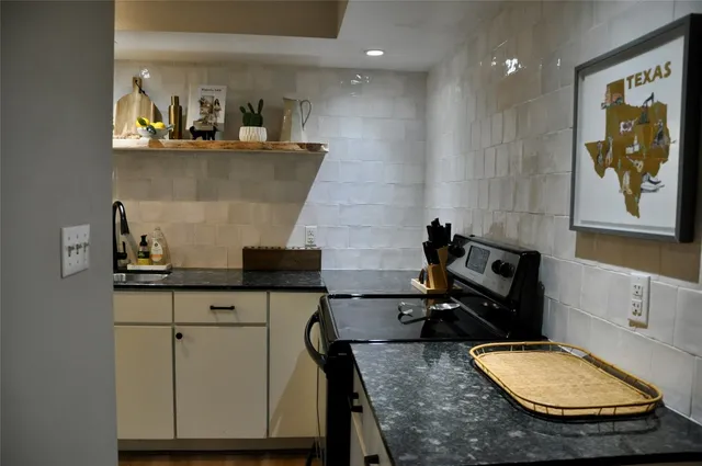 a bathroom with a granite countertop sink a mirror and vanity