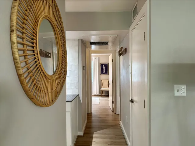 a view of a entryway door with wooden floor