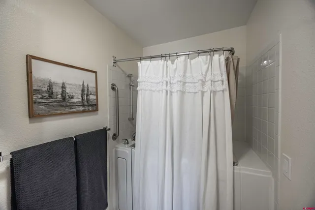 a bathroom with a sink a mirror and a shower