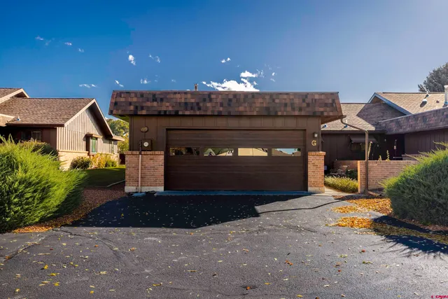 an aerial view of a house with a yard and lake view