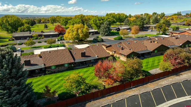 an aerial view of a house with a yard swimming pool and outdoor seating