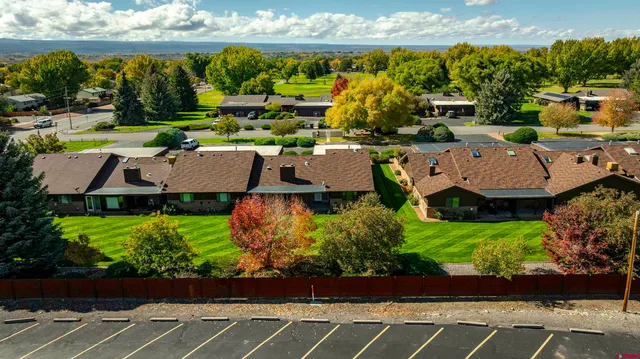 an aerial view of a house with a yard basket ball court and outdoor seating