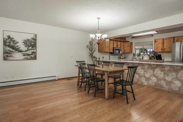 a view of a dining room with furniture wooden floor and chandelier