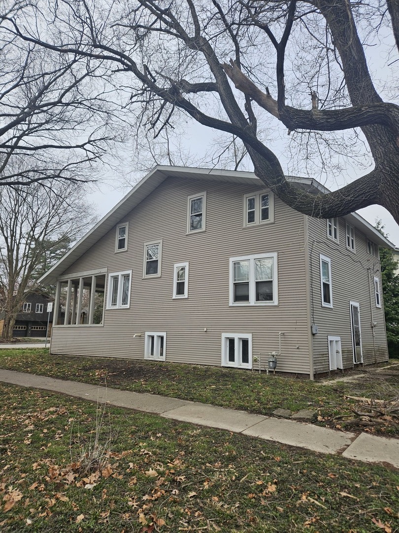 502 West John Street Champaign, IL 61820 - Photo 3 of 6 a front view of a house with a yard