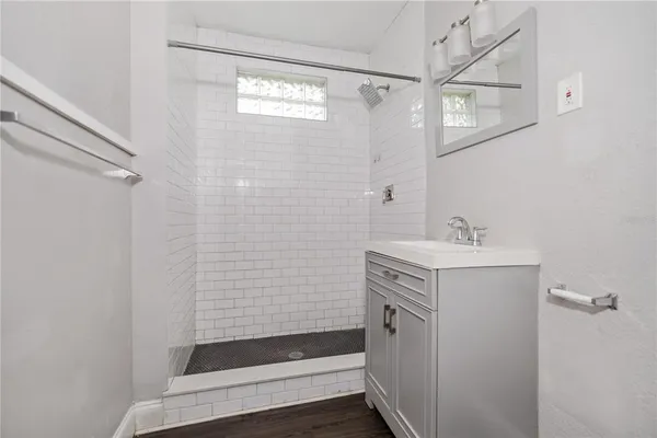 a bathroom with a sink a toilet and shower