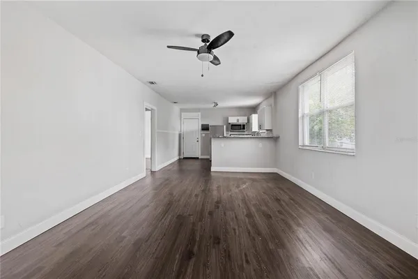 a view of a kitchen with a sink wooden floor and a window