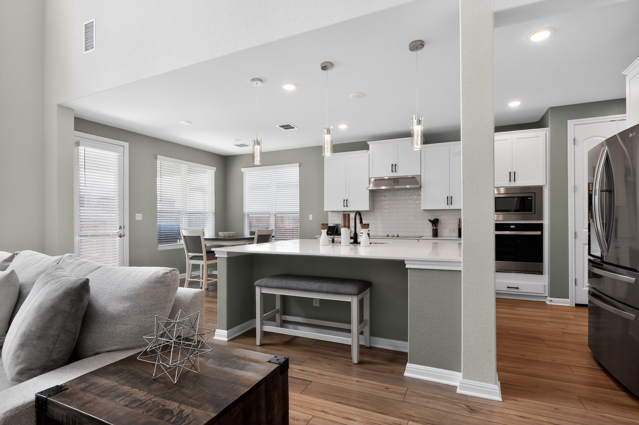 114 Bosco Road Hutto, TX 78634 - Photo 9 of 39 An open concept design seamlessly connects a bright living area with a contemporary kitchen.