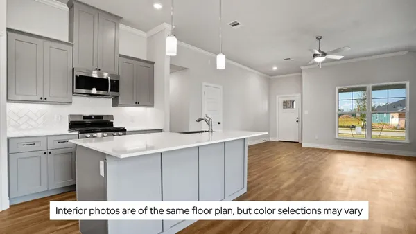 a open kitchen with kitchen island a counter space a sink stainless steel appliances and cabinets
