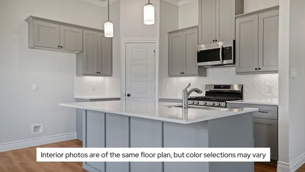 a kitchen with kitchen island a sink stainless steel appliances and cabinets