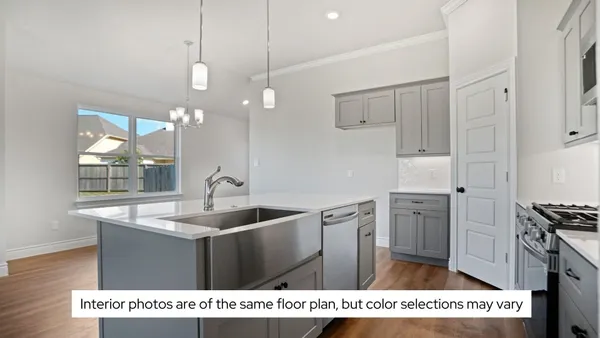 a open kitchen with cabinets and wooden floor