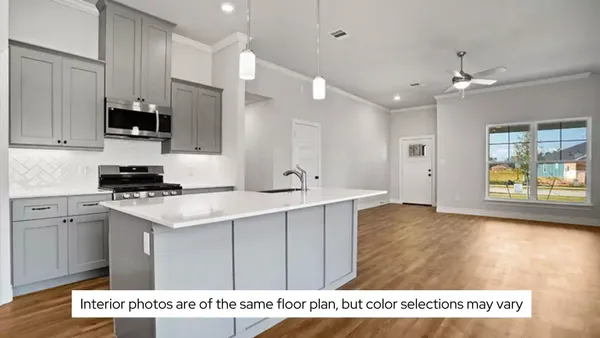 a view of kitchen with kitchen island a sink stainless steel appliances and cabinets