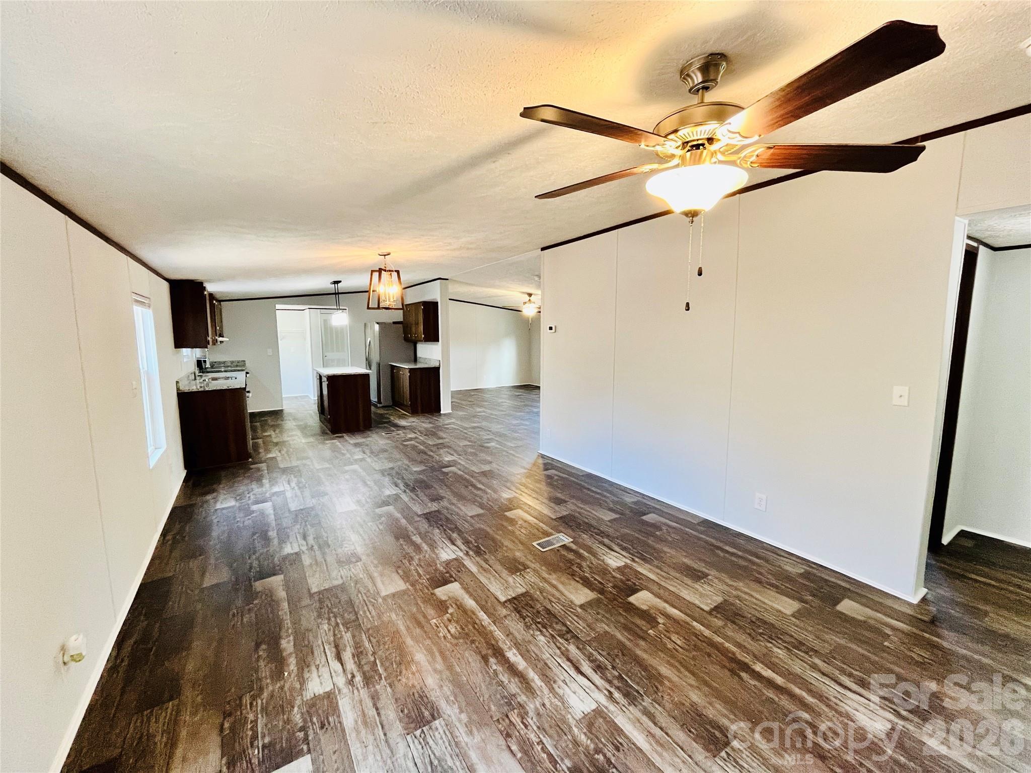 491 Sandy Springs Lane Lexington, SC 29073 - Photo 20 of 36 en empty room with wooden floor and fan