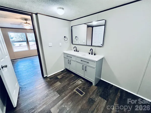 a bathroom with a sink mirror and vanity