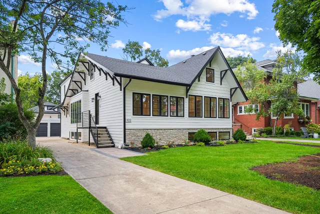 a front view of a house with a garden and plants