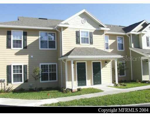 826 Enterprise Road, Unit 2101 DeBary, FL 32713 - Photo 1 of 1 a view of a yard in front of a brick house