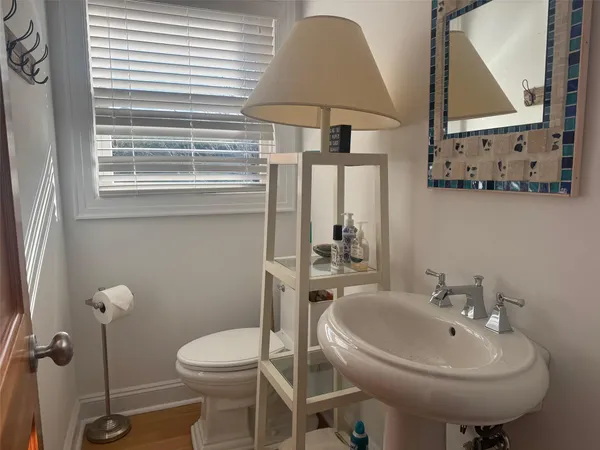 a bathroom with a toilet sink and mirror