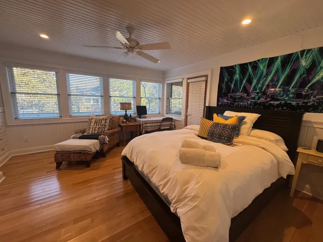 a bedroom with a large bed and a large window
