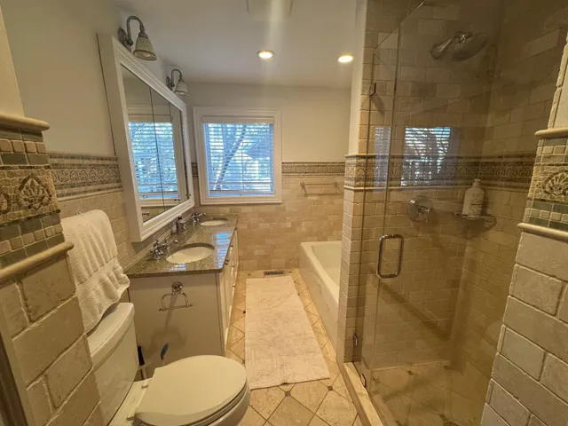 a bathroom with a toilet sink and shower