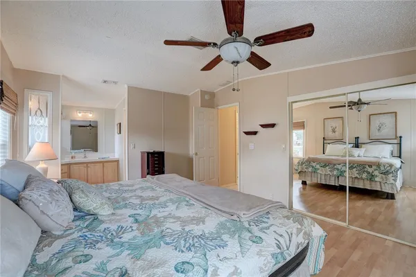 a bedroom with a bed couch and window