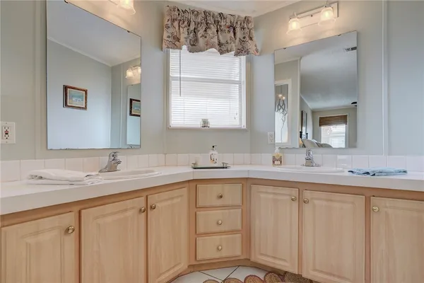 a bathroom with a granite countertop sink mirror and double