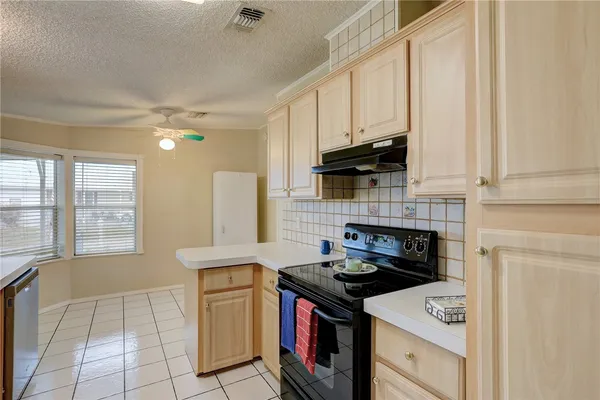 a kitchen with a stove a sink and a refrigerator