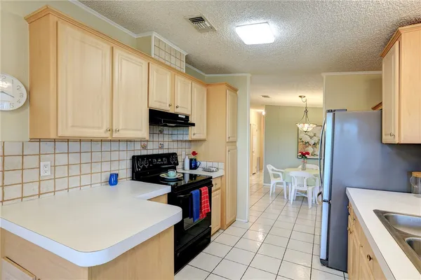 a kitchen with a sink a stove and a refrigerator