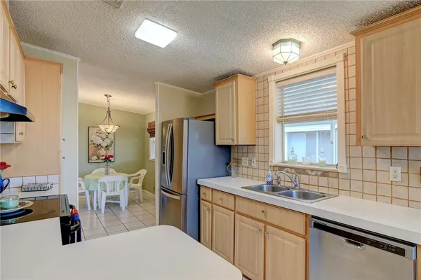 a kitchen with a sink appliances and cabinets