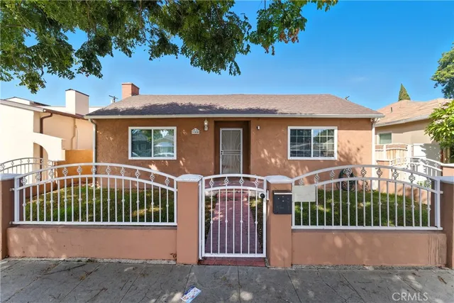 a view of a house with a wooden fence