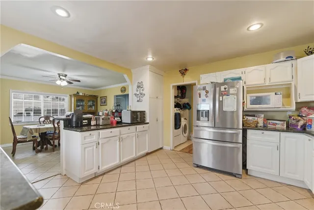 a kitchen with cabinets and stainless steel appliances