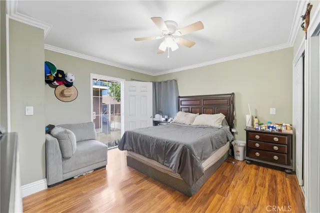 a spacious bedroom with a bed and wooden floor