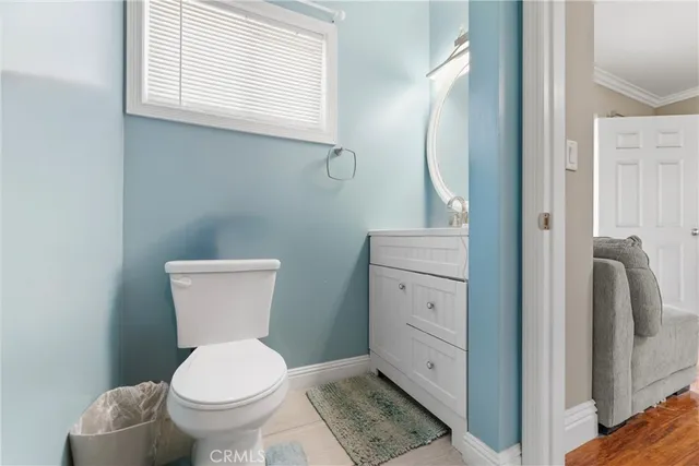 a white toilet sitting next to a bathroom sink