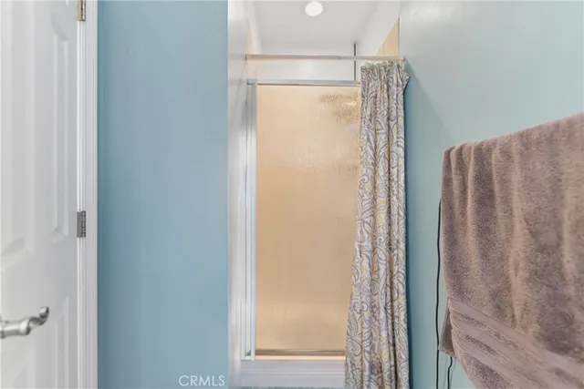 a bathroom with a glass shower door