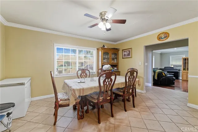 a view of a dining room with furniture and a chandelier
