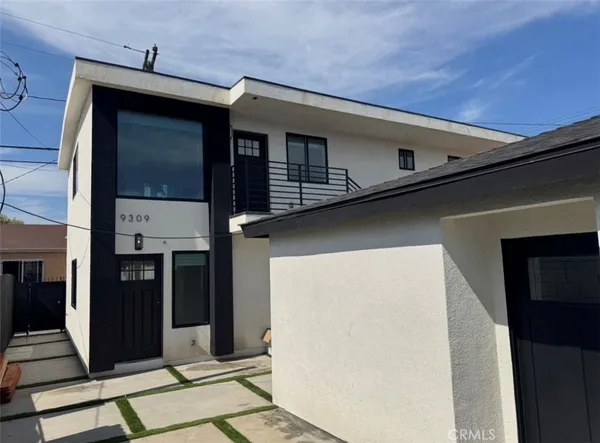 an empty room with wooden floor and entrance