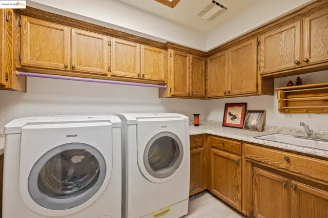 a spacious bathroom with a double vanity sink and a mirror