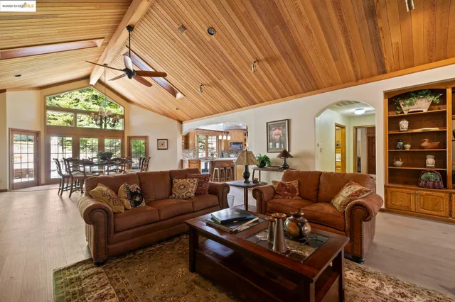a kitchen with stainless steel appliances granite countertop wooden floor window and cabinets