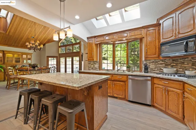 a spacious bedroom with a bed a table and large window