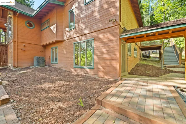 a spacious bedroom with a bed and glass window
